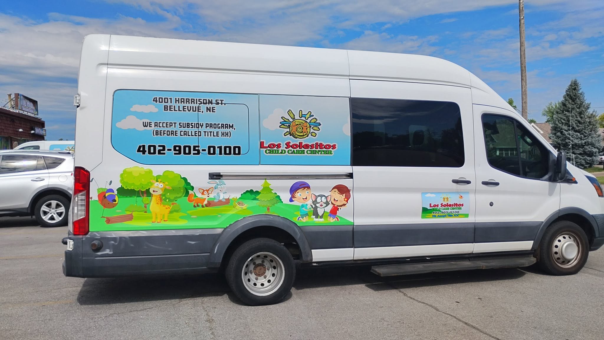 Los Solesitos Child Care Center van wrap installed by Impress